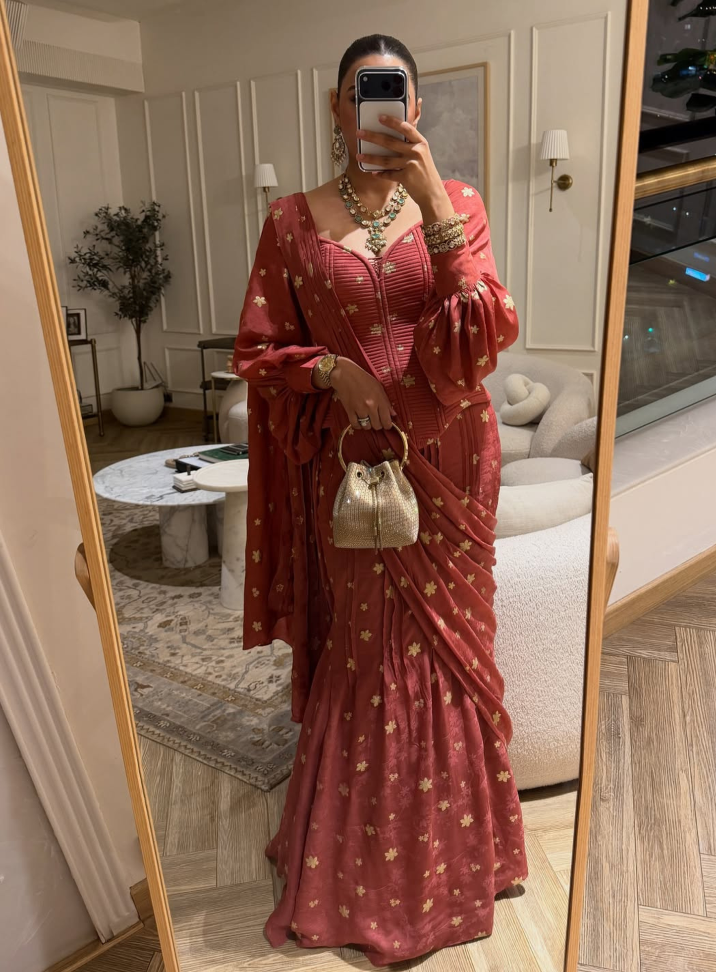 Carrot quilted corset with dramatic bishop sleeves and a fluid drape saree